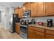 Kitchen featuring stainless steel appliances, granite countertops, and wood cabinets at 4847 Clock Tower Dr, Kissimmee, FL 34746