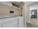 Well-organized laundry room featuring modern washer and dryer units with added shelving for storage at 4847 Clock Tower Dr, Kissimmee, FL 34746