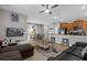 Open-concept living room featuring tile floors, ceiling fan, eat-in kitchen, and fun Mickey Mouse decor at 4847 Clock Tower Dr, Kissimmee, FL 34746
