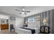 Primary bedroom suite featuring stylish decor, a ceiling fan, and a view to the ensuite bathroom at 4847 Clock Tower Dr, Kissimmee, FL 34746