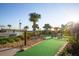 Scenic view of the community's mini-golf course, complete with lush landscaping and a water feature at 4847 Clock Tower Dr, Kissimmee, FL 34746