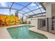 Private screened-in pool area with a whimsical mural, safety fence, and comfortable lounge chairs at 4847 Clock Tower Dr, Kissimmee, FL 34746