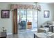 Living room with sliding glass doors leading to screened porch at 2030 Alfredo Ave, The Villages, FL 32159