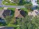 An aerial view of a home with well-maintained lawn and landscaping at 22204 Caledonia Dr, Leesburg, FL 34748