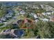 High angle view of a neighborhood with manicured lawns, mature trees, and homes with screened in pools at 22204 Caledonia Dr, Leesburg, FL 34748