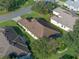 A bird's eye view of the house showing the roof and surrounding landscape at 22204 Caledonia Dr, Leesburg, FL 34748