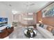 Bright living room next to dining room featuring modern furniture and a ceiling fan at 22204 Caledonia Dr, Leesburg, FL 34748