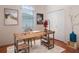 Home office with wood desk, white walls, and neutral carpet is a perfect remote working space at 22204 Caledonia Dr, Leesburg, FL 34748