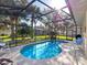 Backyard oasis features a screened in pool with a patio and plenty of room for outdoor seating at 22204 Caledonia Dr, Leesburg, FL 34748