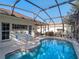 A screened-in pool area with a well-maintained patio and landscaping at 22204 Caledonia Dr, Leesburg, FL 34748