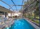 A covered pool area with outdoor seating and a relaxing atmosphere at 22204 Caledonia Dr, Leesburg, FL 34748