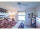 King-size bed, dresser and large window in this bedroom at 2479 Cedar Key Ln, The Villages, FL 32162