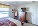 Bedroom with king bed, dresser, and TV at 2479 Cedar Key Ln, The Villages, FL 32162