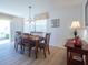 Bright dining room features a wood table with seating for six at 2479 Cedar Key Ln, The Villages, FL 32162