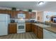 Modern kitchen, featuring wood cabinets and white appliances at 2479 Cedar Key Ln, The Villages, FL 32162