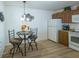 Cozy kitchen nook with breakfast table and wood cabinets at 2479 Cedar Key Ln, The Villages, FL 32162