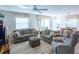 Relaxing living room, featuring neutral colored sofas and a recliner at 2479 Cedar Key Ln, The Villages, FL 32162