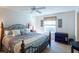 Spacious main bedroom with a king-size bed and ceiling fan at 2479 Cedar Key Ln, The Villages, FL 32162