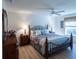 Main bedroom with king-size bed and wood nightstands at 2479 Cedar Key Ln, The Villages, FL 32162