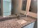 Bathroom features a single sink vanity and granite countertops at 928 Nuthatch Ave, The Villages, FL 32163