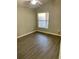 Cozy bedroom with wood floors and a bright window, perfect for relaxation at 928 Nuthatch Ave, The Villages, FL 32163