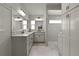 Modern bathroom features double vanity, framed mirror, and a separate glass-enclosed shower at 1132 Maynard Path, The Villages, FL 32163