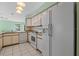 Kitchen with white appliances and light wood cabinets at 25813 Glen Eagle Dr, Leesburg, FL 34748