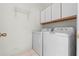 Laundry room with washer, dryer, and cabinets at 25813 Glen Eagle Dr, Leesburg, FL 34748