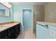 Bright bathroom featuring blue walls, granite countertop, and a glass-enclosed shower at 26701 Bimini Dr, Tavares, FL 32778