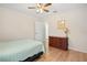 Bedroom with queen bed, light teal bedding, and wood dresser at 26701 Bimini Dr, Tavares, FL 32778