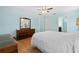 Bedroom with wood floors, dresser and a ceiling fan at 26701 Bimini Dr, Tavares, FL 32778