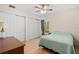 Bedroom with queen bed, light teal bedding, and ample closet space at 26701 Bimini Dr, Tavares, FL 32778