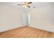 Bright bedroom featuring wood floors, a ceiling fan, and a neutral color palette at 26701 Bimini Dr, Tavares, FL 32778