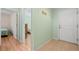 Bright entryway with light green walls and wood flooring at 26701 Bimini Dr, Tavares, FL 32778