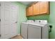 Laundry room with washer, dryer, and ample cabinets at 26701 Bimini Dr, Tavares, FL 32778