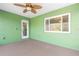 Covered patio with ceiling fan and access door at 26701 Bimini Dr, Tavares, FL 32778