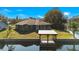 Back of house with backyard, dock and canal access at 26701 Bimini Dr, Tavares, FL 32778