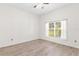 Bright bedroom with wood-look floors and large window at 6178 Spinnaker Loop, Lady Lake, FL 32159