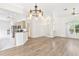 Open concept dining room with hardwood floors and chandelier at 6178 Spinnaker Loop, Lady Lake, FL 32159