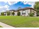 House exterior with landscaping and palm trees at 6178 Spinnaker Loop, Lady Lake, FL 32159