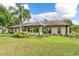 Backyard view of single-story home with landscaping at 6178 Spinnaker Loop, Lady Lake, FL 32159