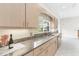 View of kitchen with granite counters and wood cabinets at 6178 Spinnaker Loop, Lady Lake, FL 32159