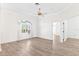 Bright living room with wood-look floors and an arched window at 6178 Spinnaker Loop, Lady Lake, FL 32159