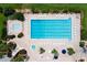 Aerial view of community pool with lounge chairs and small spa at 6178 Spinnaker Loop, Lady Lake, FL 32159