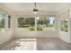 Sunroom with wood-look floors and large windows at 6178 Spinnaker Loop, Lady Lake, FL 32159