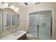 Well-lit bathroom with a walk-in shower, stylish vanity, and tiled floors at 9345 Silver Lake Dr, Leesburg, FL 34788