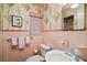 This bathroom features floral wallpaper, tile accents, and standard fixtures at 9345 Silver Lake Dr, Leesburg, FL 34788