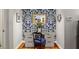 Dressing area features a vanity, chair and bold designer wallpaper at 9345 Silver Lake Dr, Leesburg, FL 34788