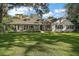 Charming one-story home with manicured lawn and mature trees in daytime at 9345 Silver Lake Dr, Leesburg, FL 34788