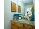 Bathroom with granite countertop and wood cabinets at 1314 Lajolla Cir, The Villages, FL 32159